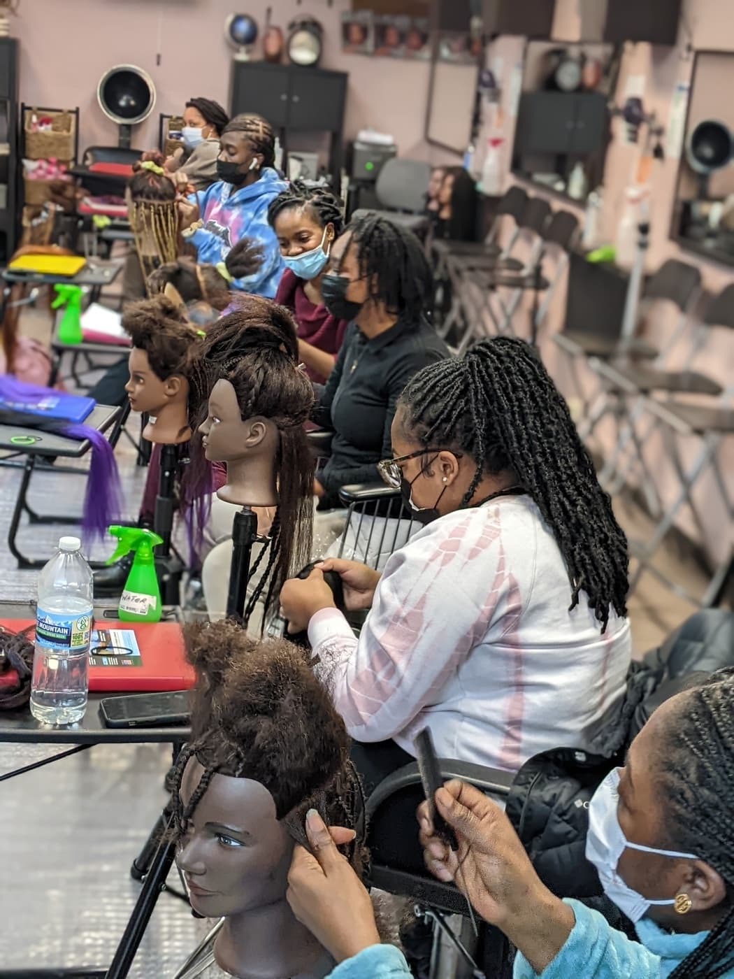 LYS students practicing braiding techniques at their workstations