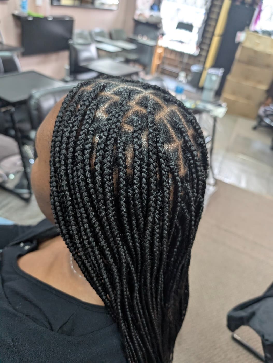 Close-up of clean box parting technique on knotless braids